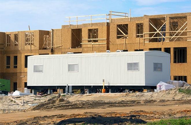 construction workers discussing plans in a rental office in Hopkinton